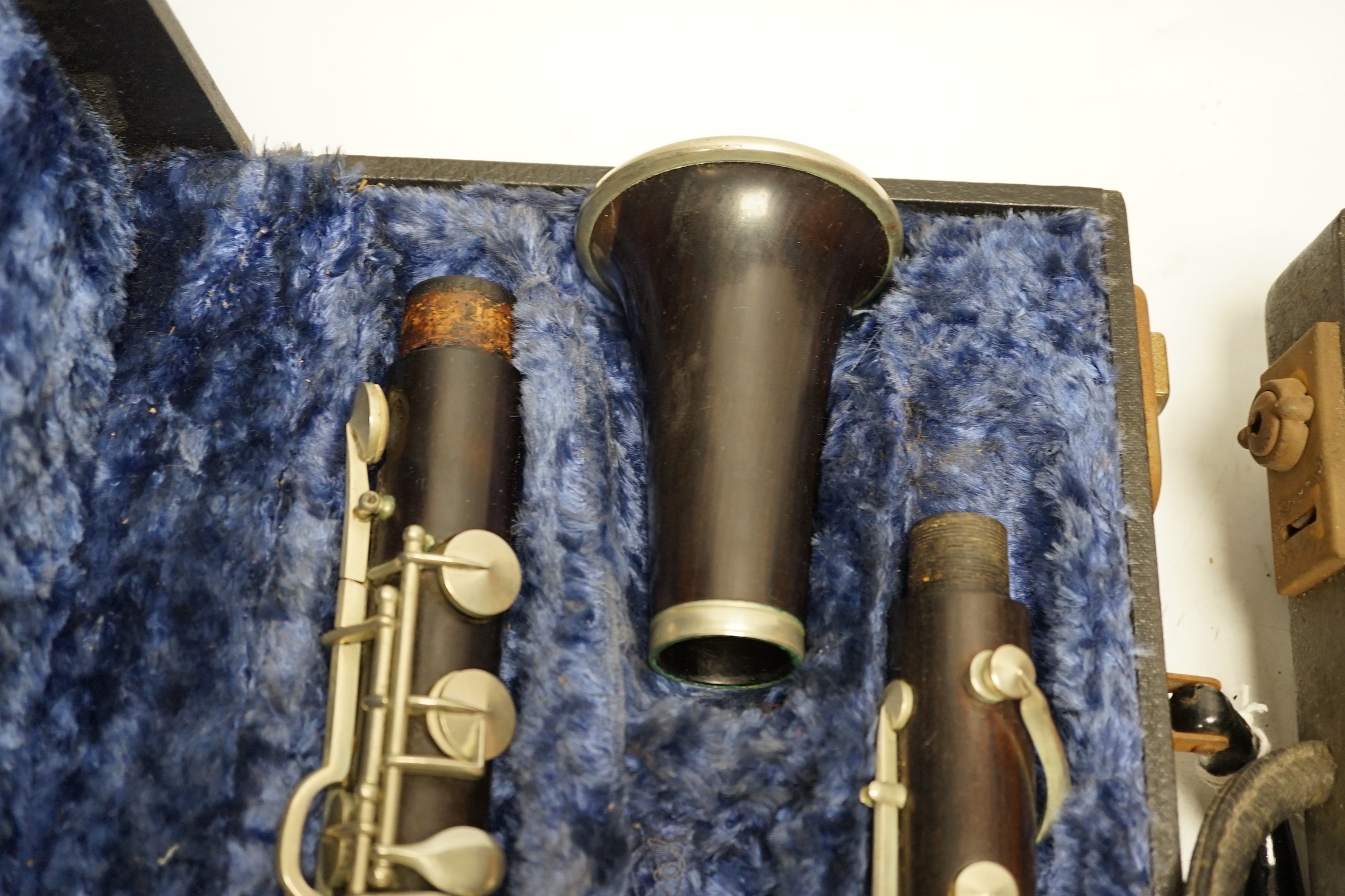 Two cased unmarked clarinets with early key systems, one mid 19th century in rosewood, one with light brown Bakelite body